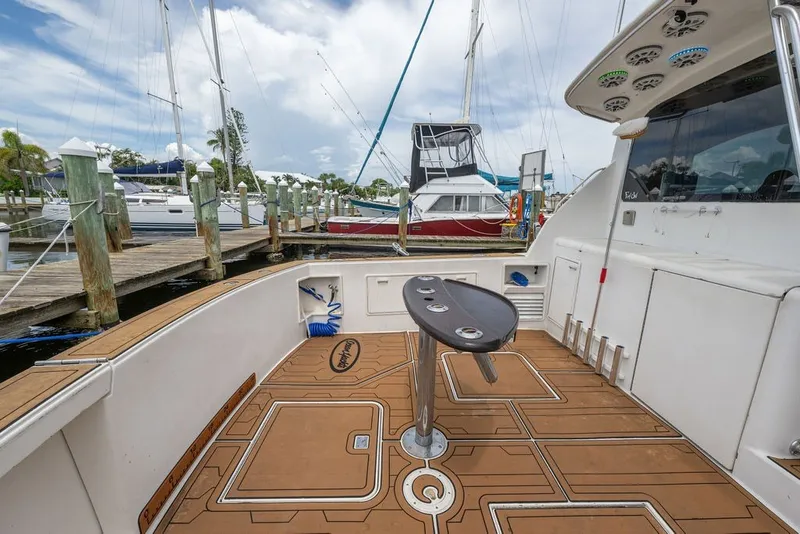 Slide: The Image of 1997 Ocean Yachts 40 Super Sport docked, featuring spacious deck and fishing rod holders. - 39