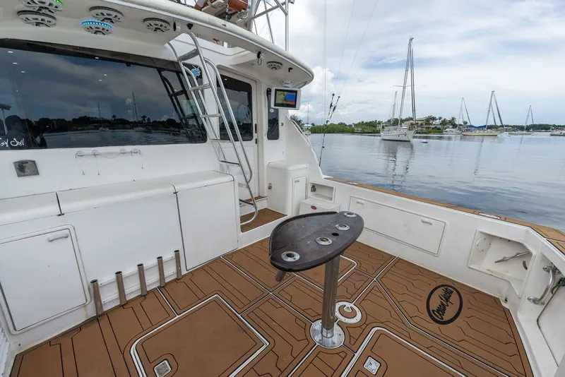 Slide: The Image of 1997 Ocean Yachts 40 Super Sport boat deck with fishing rod holders and scenic marina view. - 37