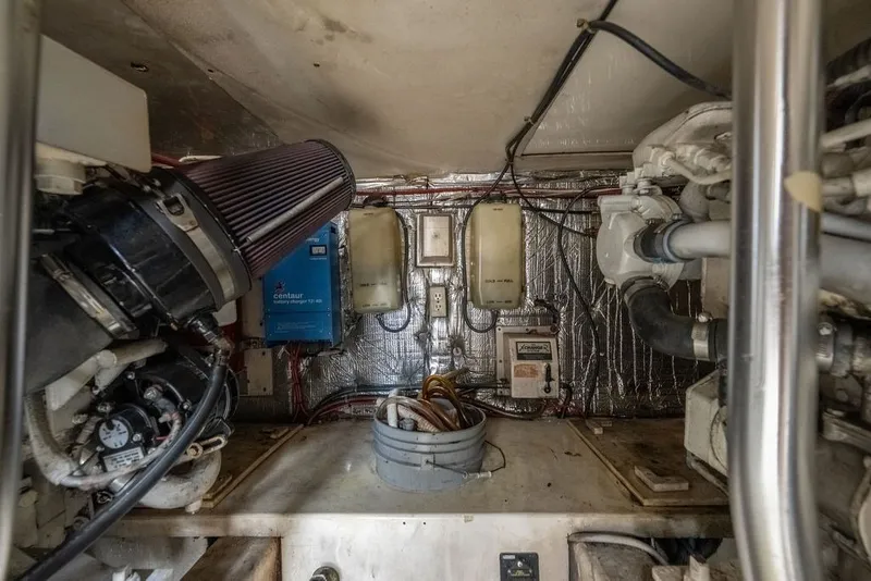 Slide: The Image of Engine room of a 1997 Ocean Yachts 40 Super Sport, showcasing mechanical components and wiring. - 73