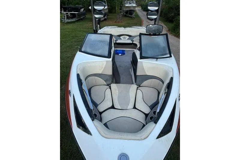 Slide: The Image of 2013 Malibu Wakesetter 23 LSV boat interior with seating and open compartments. - 6