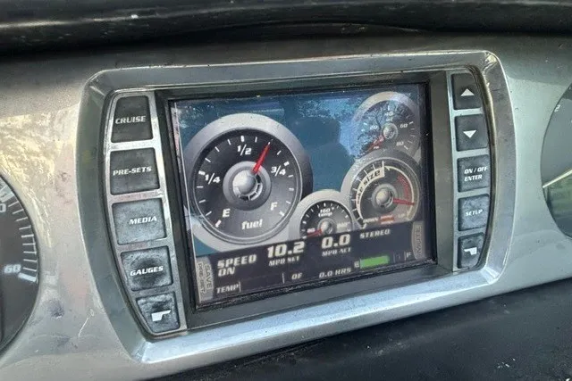 Slide: The Image of Dashboard display of a 2013 Malibu Wakesetter 23 LSV showing speed and fuel gauges. - 11