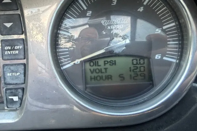 Slide: The Image of Dashboard of 2013 Malibu Wakesetter 23 LSV showing oil PSI, voltage, and hours. - 13