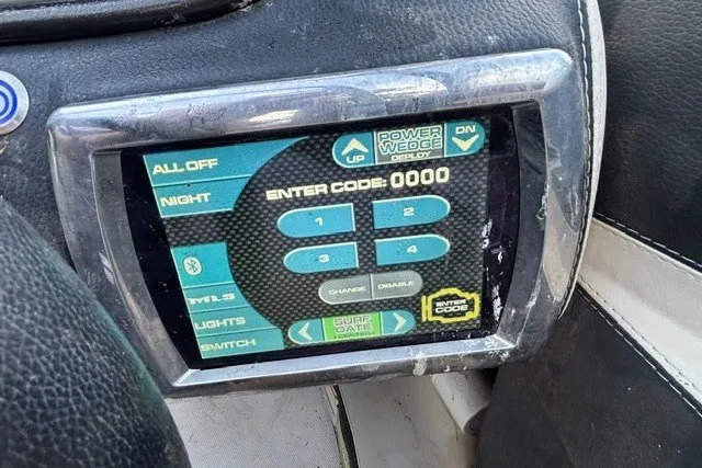 Slide: The Image of Control panel of a 2013 Malibu Wakesetter 23 LSV boat with security code entry. - 12