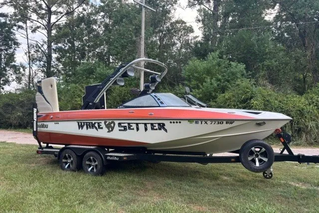 The Image of 2013 Malibu Wakesetter 23 LSV boat on trailer, parked on grass. - 1