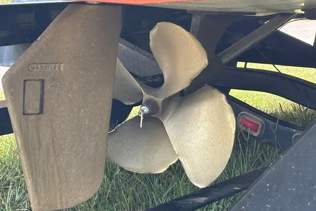 Slide: The Image of Propeller of 2013 Malibu Wakesetter 23 LSV boat on grass. - 5