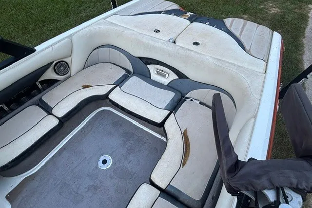 Slide: The Image of 2013 Malibu Wakesetter 23 LSV interior with white and gray seating, outdoor setting. - 9