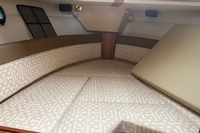Slide: The Image of 2018 Ranger Tugs R-27 cabin interior with patterned cushions and cozy seating. - 24