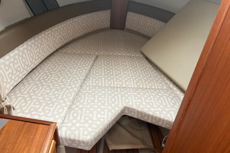 Slide: The Image of 2018 Ranger Tugs R-27 cabin interior with patterned cushions and wooden accents. - 23