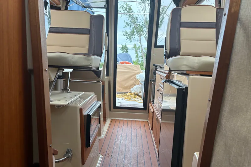 Slide: The Image of Interior of 2018 Ranger Tugs R-27 boat with seating and wooden flooring. - 25