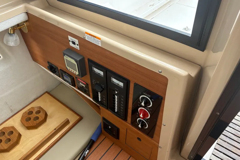 Slide: The Image of Control panel of a 2018 Ranger Tugs R-27 boat with switches and gauges. - 18