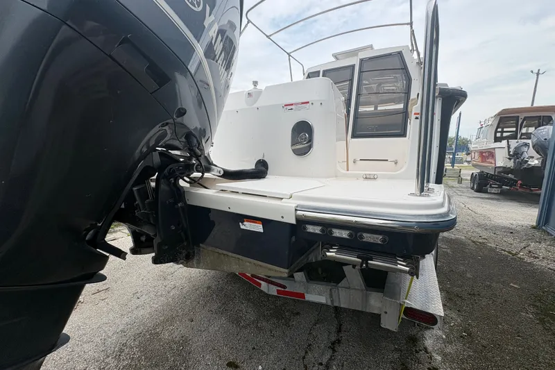 Slide: The Image of 2018 Ranger Tugs R-27 boat with Yamaha outboard motor, rear view on trailer. - 9