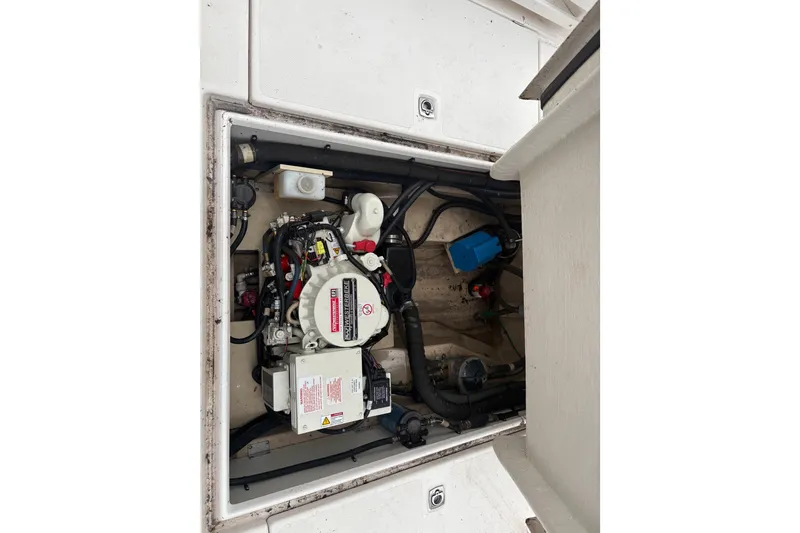 Slide: The Image of Engine compartment of 2018 Ranger Tugs R-27 boat, showcasing mechanical components and wiring. - 29