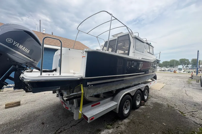 Slide: The Image of 2018 Ranger Tugs R-27 boat on a trailer, featuring a Yamaha outboard motor. - 6