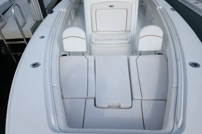 Slide: The Image of 2021 Sea Hunt Gamefish 27FS boat interior with white cushioned seating arrangement. - 8