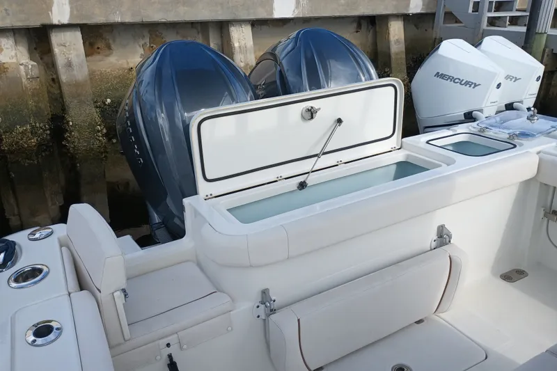 Slide: The Image of 2021 Sea Hunt Gamefish 27FS boat with dual outboard motors and seating area. - 24