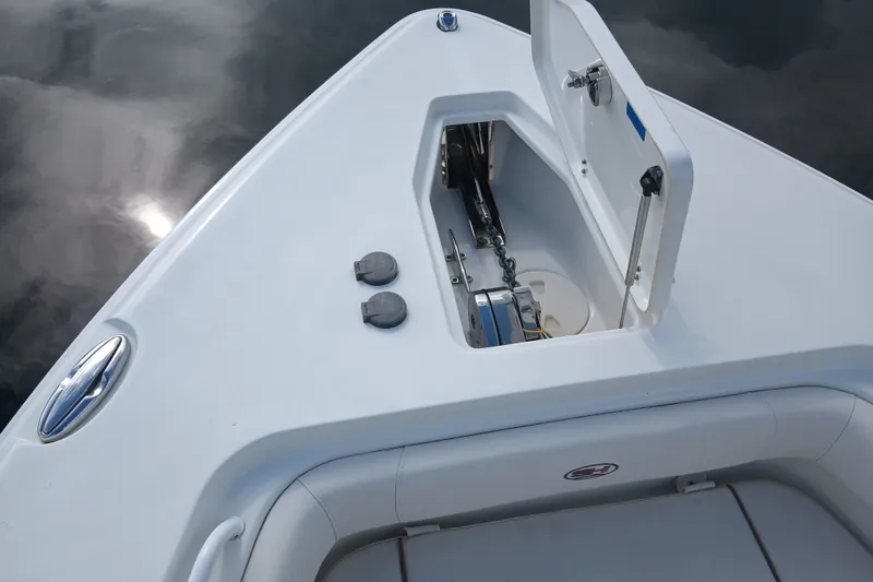 Slide: The Image of 2021 Sea Hunt Gamefish 27FS boat anchor compartment with open hatch. - 9