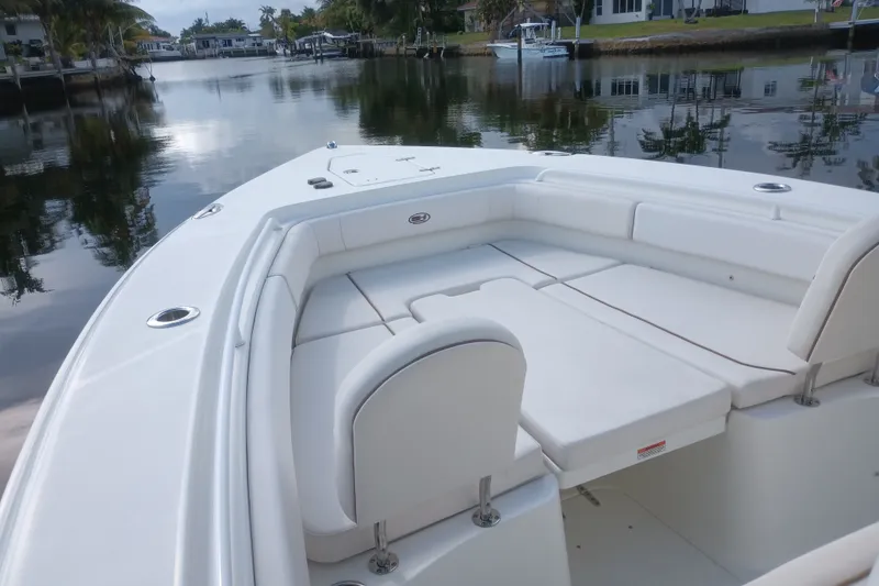 Slide: The Image of 2021 Sea Hunt Gamefish 27FS boat with spacious seating on calm water. - 10