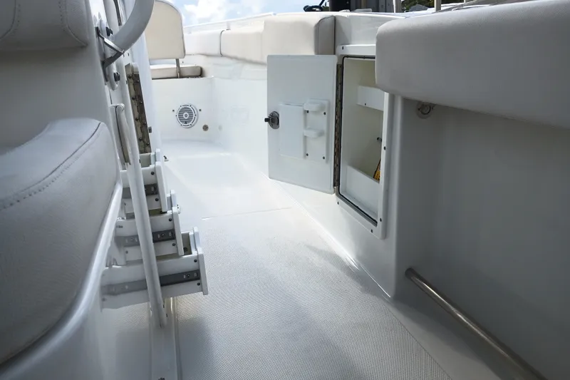 Slide: The Image of 2021 Sea Hunt Gamefish 27FS interior with open storage compartment and seating. - 28