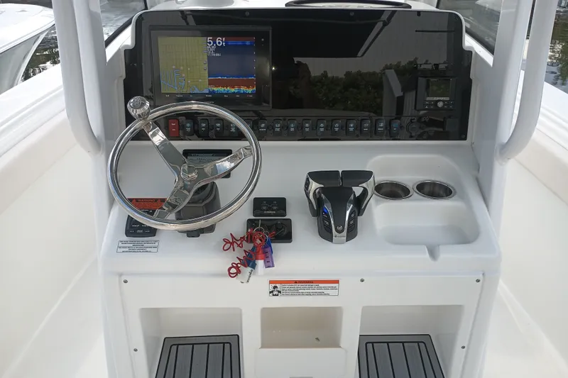 Slide: The Image of Control panel of a 2021 Sea Hunt Gamefish 27FS boat with steering wheel and electronics. - 17