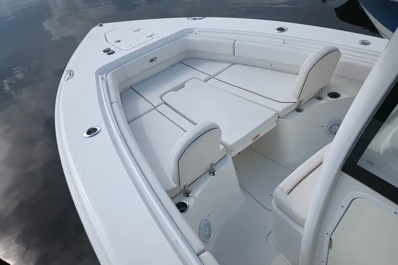 Slide: The Image of 2021 Sea Hunt Gamefish 27FS boat interior with white cushioned seating. - 11