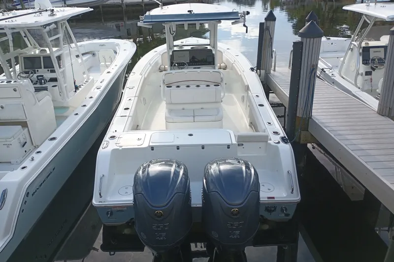 Slide: The Image of 2021 Sea Hunt Gamefish 27FS boat docked with dual engines, ready for fishing adventures. - 5