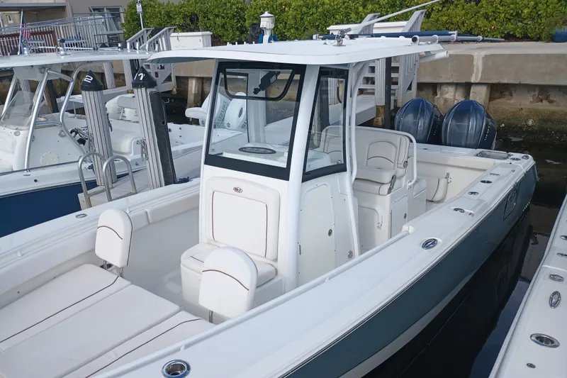 Slide: The Image of 2021 Sea Hunt Gamefish 27FS boat docked, featuring spacious seating and dual engines. - 4