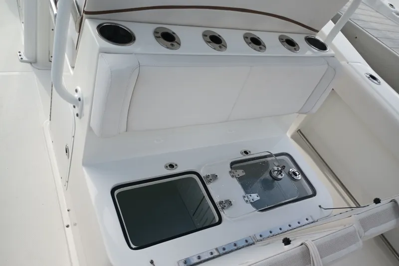 Slide: The Image of 2021 Sea Hunt Gamefish 27FS boat interior with rod holders and storage compartment. - 23