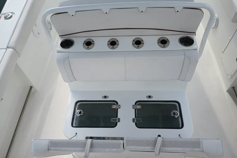 Slide: The Image of 2021 Sea Hunt Gamefish 27FS boat interior with rod holders and storage compartments. - 22
