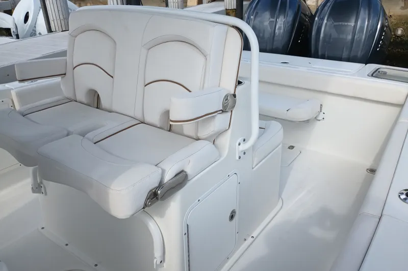Slide: The Image of 2021 Sea Hunt Gamefish 27FS boat interior with white seating and dual engines. - 20
