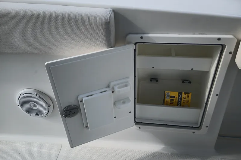 Slide: The Image of Open storage compartment on 2021 Sea Hunt Gamefish 27FS boat, featuring battery storage. - 29