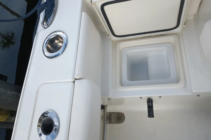 Slide: The Image of 2021 Sea Hunt Gamefish 27FS boat interior with storage compartment and cup holders. - 30