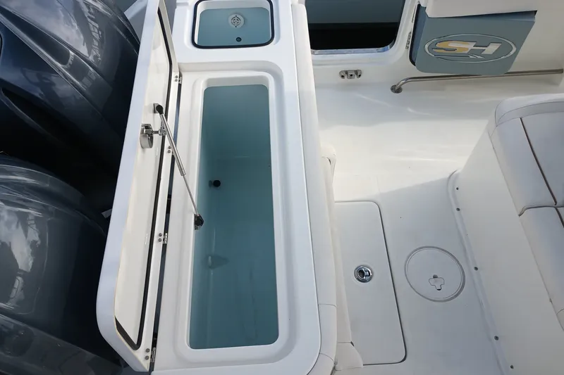 Slide: The Image of 2021 Sea Hunt Gamefish 27FS boat interior with open storage compartment. - 25