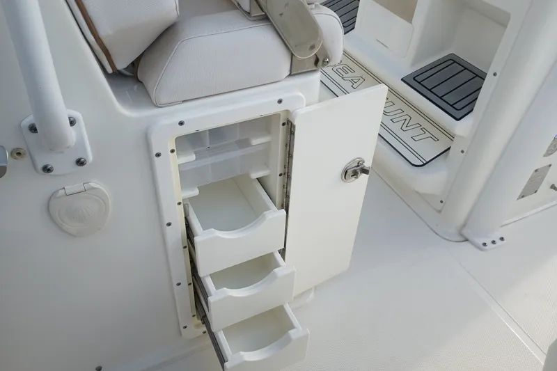 Slide: The Image of 2021 Sea Hunt Gamefish 27FS boat interior with open storage drawers. - 27