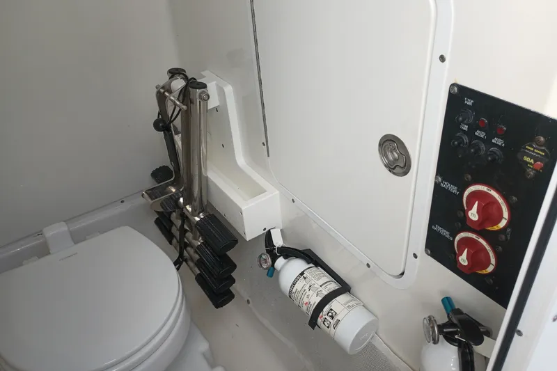 Slide: The Image of Interior of a 2021 Sea Hunt Gamefish 27FS boat featuring a toilet and control panel. - 34