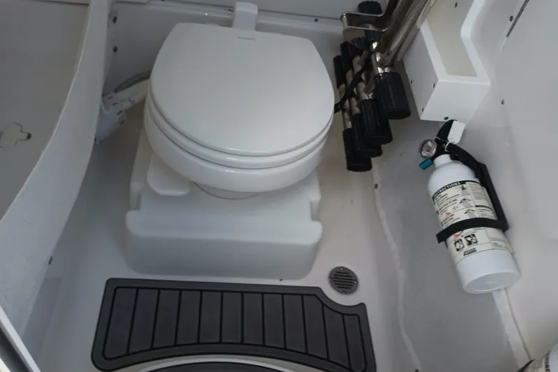 Slide: The Image of 2021 Sea Hunt Gamefish 27FS boat interior with toilet and fire extinguisher. - 33