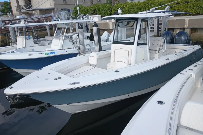 The Image of 2021 Sea Hunt Gamefish 27FS boat docked, featuring sleek design and spacious seating. - 3