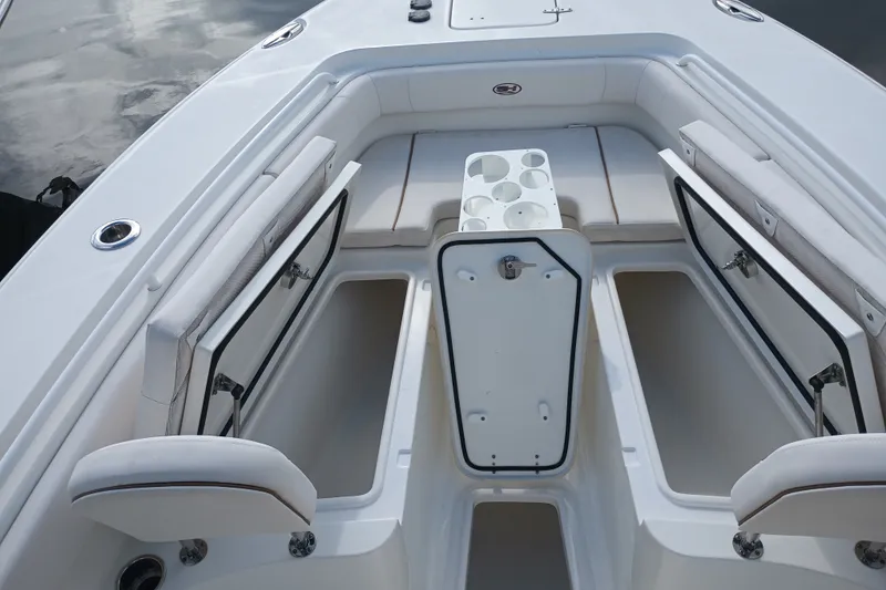 Slide: The Image of 2021 Sea Hunt Gamefish 27FS boat interior with open storage compartments and seating. - 13