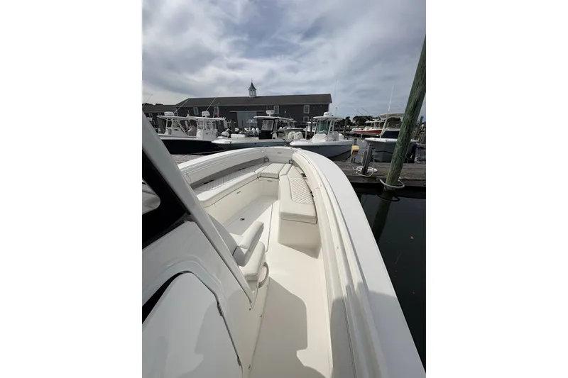 Slide: The Image of 2025 Regulator 25 boat docked at marina under cloudy sky. - 4