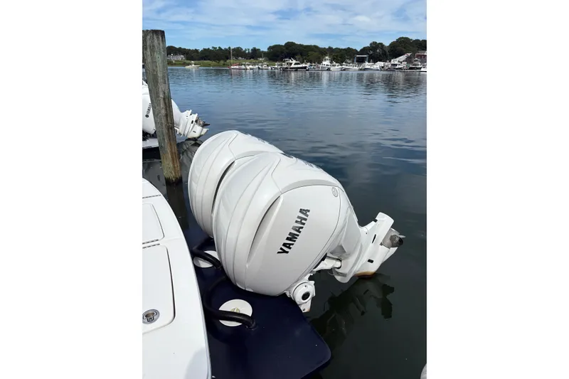 Slide: The Image of 2025 Regulator 25 boat with Yamaha outboard engines docked by the water. - 9