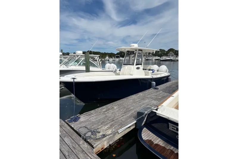 The Image of 2025 Regulator 25 boat docked at marina under clear sky. - 0