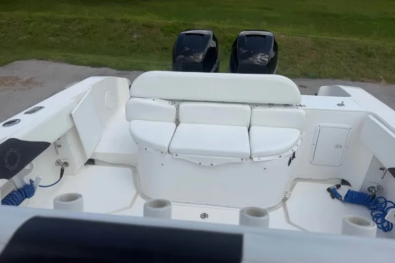 Slide: The Image of 2006 Fountain 32 Center Console boat with white seating and dual engines. - 16