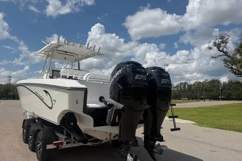 Slide: The Image of 2006 Fountain 32 Center Console boat with twin Mercury 275 engines on a trailer. - 17