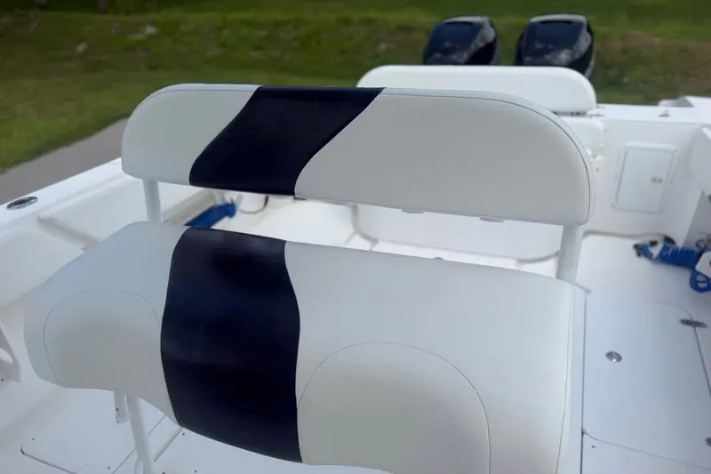 Slide: The Image of 2006 Fountain 32 Center Console boat seating with black and white upholstery. - 12