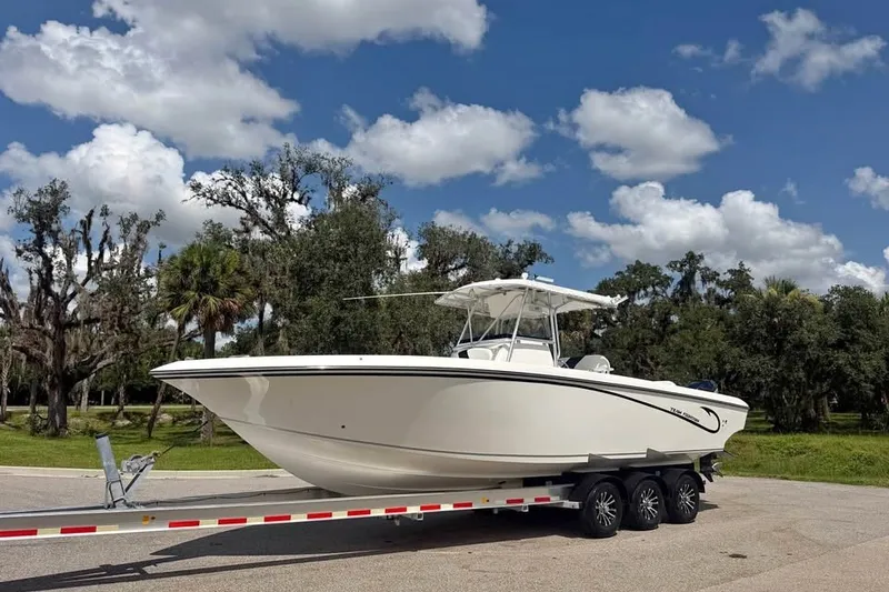 Slide: The Image of 2006 Fountain 32 Center Console boat on trailer under blue sky. - 1