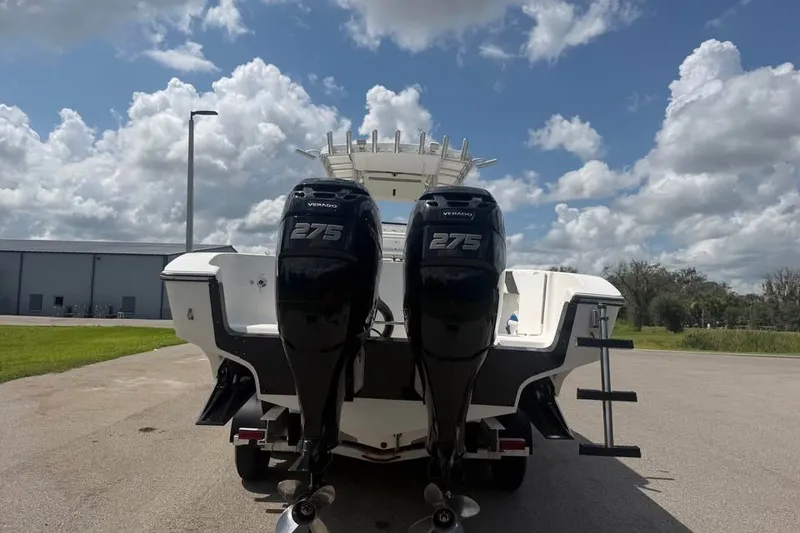 Slide: The Image of 2006 Fountain 32 Center Console boat with twin 275 Verado engines, parked outdoors. - 18