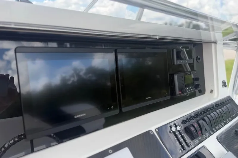 Slide: The Image of 2006 Fountain 32 Center Console dashboard with Garmin displays and control panel. - 14