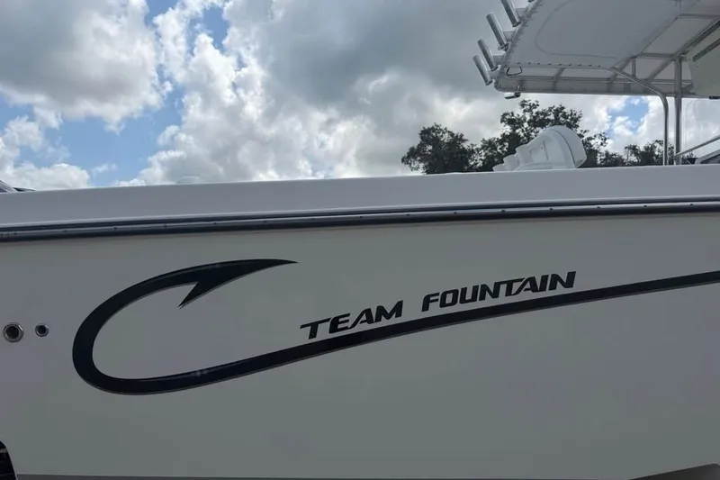 Slide: The Image of 2006 Fountain 32 Center Console boat with "Team Fountain" logo under cloudy sky. - 8