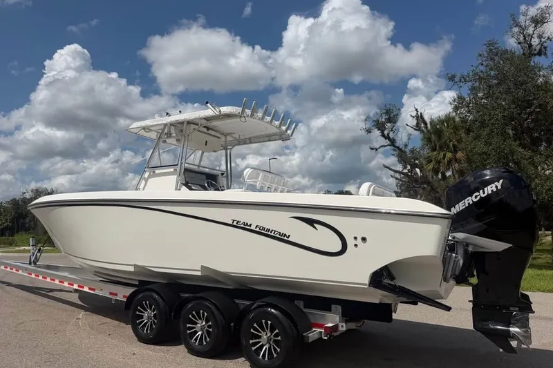 Slide: The Image of 2006 Fountain 32 Center Console boat on trailer under cloudy sky. - 6