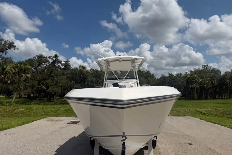 Slide: The Image of 2006 Fountain 32 Center Console boat on trailer under cloudy sky. - 4
