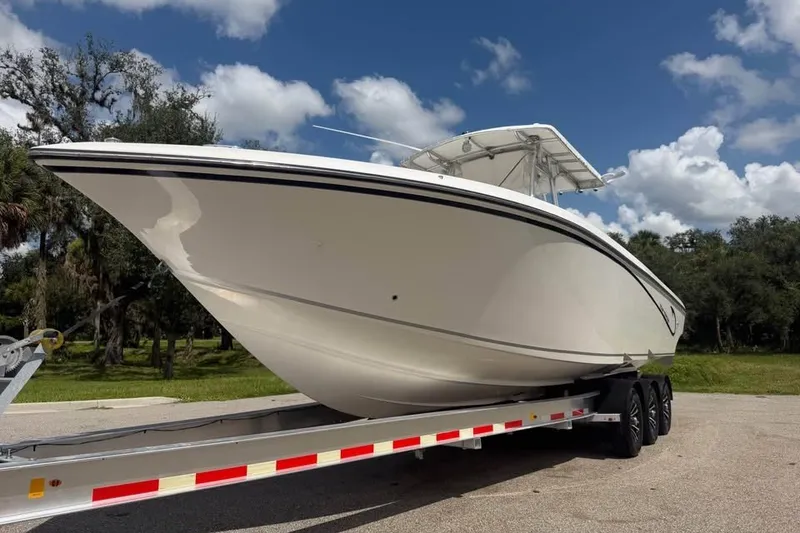 Slide: The Image of 2006 Fountain 32 Center Console boat on trailer under blue sky. - 2